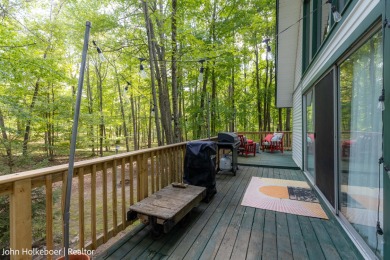 Welcome to this distinctive four-bedroom, three-bath chalet on Canadian Lakes Country Club-The Royal Course in Michigan - for sale on GolfHomes.com, golf home, golf lot