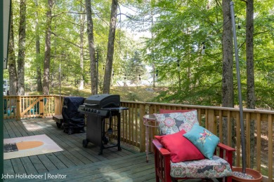Welcome to this distinctive four-bedroom, three-bath chalet on Canadian Lakes Country Club-The Royal Course in Michigan - for sale on GolfHomes.com, golf home, golf lot