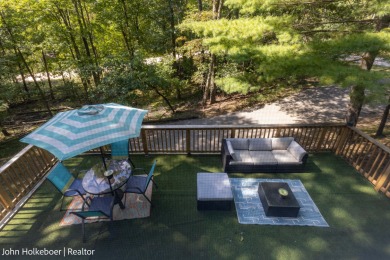 Welcome to this distinctive four-bedroom, three-bath chalet on Canadian Lakes Country Club-The Royal Course in Michigan - for sale on GolfHomes.com, golf home, golf lot