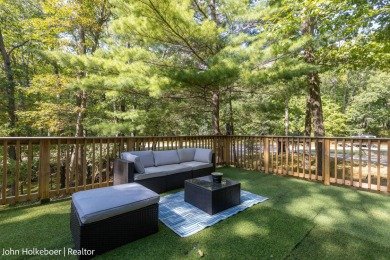 Welcome to this distinctive four-bedroom, three-bath chalet on Canadian Lakes Country Club-The Royal Course in Michigan - for sale on GolfHomes.com, golf home, golf lot