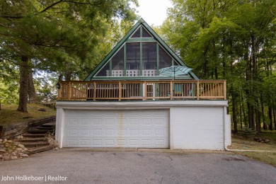 Welcome to this distinctive four-bedroom, three-bath chalet on Canadian Lakes Country Club-The Royal Course in Michigan - for sale on GolfHomes.com, golf home, golf lot