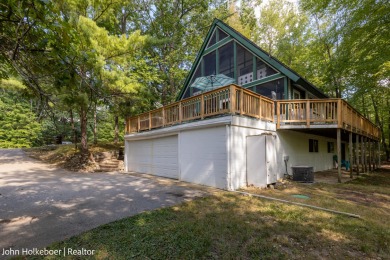 Welcome to this distinctive four-bedroom, three-bath chalet on Canadian Lakes Country Club-The Royal Course in Michigan - for sale on GolfHomes.com, golf home, golf lot