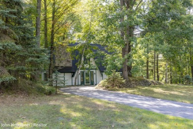 Welcome to this distinctive four-bedroom, three-bath chalet on Canadian Lakes Country Club-The Royal Course in Michigan - for sale on GolfHomes.com, golf home, golf lot