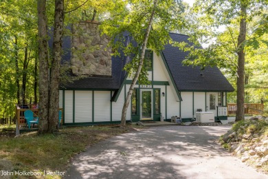 Welcome to this distinctive four-bedroom, three-bath chalet on Canadian Lakes Country Club-The Royal Course in Michigan - for sale on GolfHomes.com, golf home, golf lot