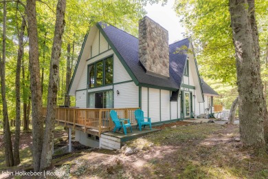 Welcome to this distinctive four-bedroom, three-bath chalet on Canadian Lakes Country Club-The Royal Course in Michigan - for sale on GolfHomes.com, golf home, golf lot
