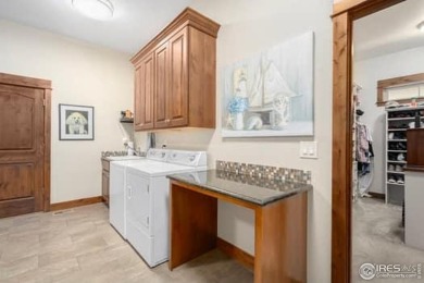 This custom ranch home on a stunning waterfront lot offers an on Pelican Lakes Golf and Country Club in Colorado - for sale on GolfHomes.com, golf home, golf lot