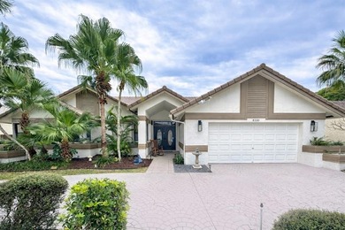Hurry and take a look at this tropical, spacious pool home in La on Woodmont Country Club in Florida - for sale on GolfHomes.com, golf home, golf lot