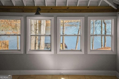 A stone's throw from the water's edge, this lakefront cottage is on Chattahoochee Golf Course in Georgia - for sale on GolfHomes.com, golf home, golf lot