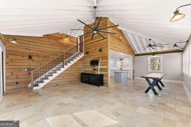 A stone's throw from the water's edge, this lakefront cottage is on Chattahoochee Golf Course in Georgia - for sale on GolfHomes.com, golf home, golf lot