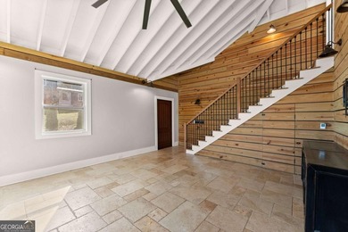 A stone's throw from the water's edge, this lakefront cottage is on Chattahoochee Golf Course in Georgia - for sale on GolfHomes.com, golf home, golf lot