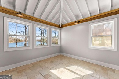 A stone's throw from the water's edge, this lakefront cottage is on Chattahoochee Golf Course in Georgia - for sale on GolfHomes.com, golf home, golf lot