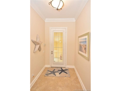 This Bermuda with it's inviting front porch and open-kitchen on The Florida Club in Florida - for sale on GolfHomes.com, golf home, golf lot