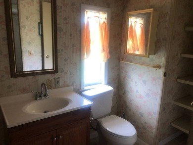 Located in the desirable gated, 55+ community this charming on Golden Lakes Golf Course in Florida - for sale on GolfHomes.com, golf home, golf lot