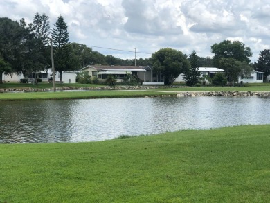Located in the desirable gated, 55+ community this charming on Golden Lakes Golf Course in Florida - for sale on GolfHomes.com, golf home, golf lot