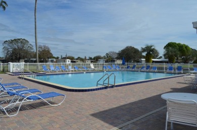 Located in the desirable gated, 55+ community this charming on Golden Lakes Golf Course in Florida - for sale on GolfHomes.com, golf home, golf lot