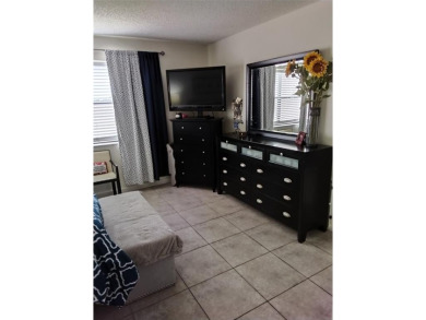 Nicely upgraded, top floor, fully tiled condo with screened on Sunrise Lakes Phase IV Golf Course in Florida - for sale on GolfHomes.com, golf home, golf lot