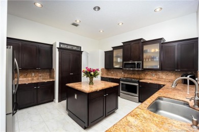 Nestled on a serene one-acre lot along the 6th fairway of on Evergreen Club in Florida - for sale on GolfHomes.com, golf home, golf lot