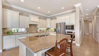 Positioned on a premier south-facing homesite with serene lake on Ritz-Carlton Members Golf Club in Florida - for sale on GolfHomes.com, golf home, golf lot