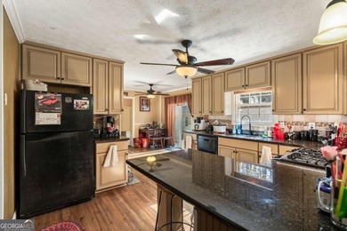 Welcome home to this beautiful contemporary home, spread out on on Canongate At Georgia National Golf Club in Georgia - for sale on GolfHomes.com, golf home, golf lot