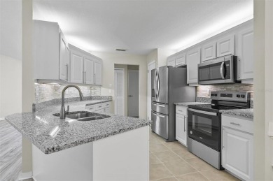 Light-Filled Designer Pool Home | New Roof | Gourmet Kitchen | on The Grand Club - Pine Lakes Course in Florida - for sale on GolfHomes.com, golf home, golf lot