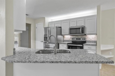 Light-Filled Designer Pool Home | New Roof | Gourmet Kitchen | on The Grand Club - Pine Lakes Course in Florida - for sale on GolfHomes.com, golf home, golf lot