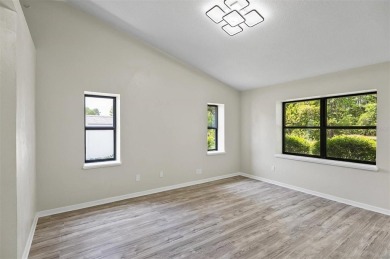 Light-Filled Designer Pool Home | New Roof | Gourmet Kitchen | on The Grand Club - Pine Lakes Course in Florida - for sale on GolfHomes.com, golf home, golf lot