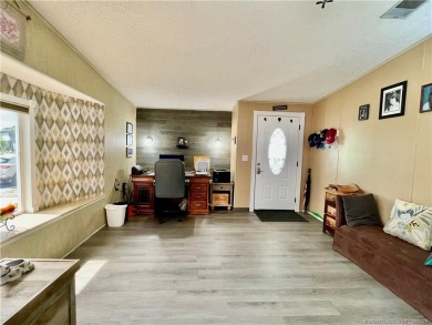 Lovely home with new wood laminate flooring throughout & extra on Indianwood Golf and Country Club in Florida - for sale on GolfHomes.com, golf home, golf lot