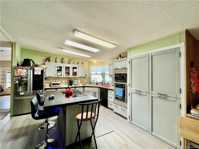 Lovely home with new wood laminate flooring throughout & extra on Indianwood Golf and Country Club in Florida - for sale on GolfHomes.com, golf home, golf lot