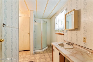 Adorable vintage Cantway doublewide manufactured home provides on The Oaks Golf Club in Florida - for sale on GolfHomes.com, golf home, golf lot