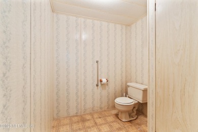 Adorable vintage Cantway doublewide manufactured home provides on The Oaks Golf Club in Florida - for sale on GolfHomes.com, golf home, golf lot