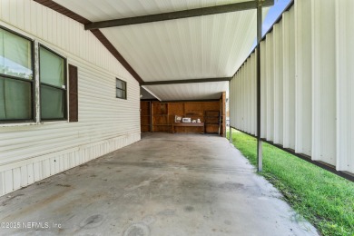 Adorable vintage Cantway doublewide manufactured home provides on The Oaks Golf Club in Florida - for sale on GolfHomes.com, golf home, golf lot