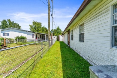 Adorable vintage Cantway doublewide manufactured home provides on The Oaks Golf Club in Florida - for sale on GolfHomes.com, golf home, golf lot