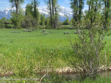 Enjoy beautiful Grand Teton views from this premier .84 acre lot on Jackson Hole Golf and Tennis Club in Wyoming - for sale on GolfHomes.com, golf home, golf lot