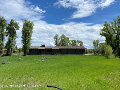 Enjoy beautiful Grand Teton views from this premier .84 acre lot on Jackson Hole Golf and Tennis Club in Wyoming - for sale on GolfHomes.com, golf home, golf lot