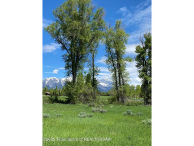 Enjoy beautiful Grand Teton views from this premier .84 acre lot on Jackson Hole Golf and Tennis Club in Wyoming - for sale on GolfHomes.com, golf home, golf lot