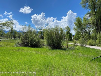 Enjoy beautiful Grand Teton views from this premier .84 acre lot on Jackson Hole Golf and Tennis Club in Wyoming - for sale on GolfHomes.com, golf home, golf lot
