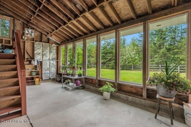 This impeccably maintained Priest Lake home perfectly blends on Priest Lake Golf and Tennis Club in Idaho - for sale on GolfHomes.com, golf home, golf lot