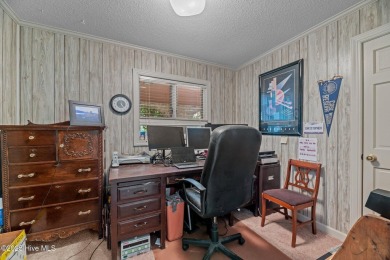 This Mediterranean-style brick home offers panoramic views of on Harbour Point Golf Club in North Carolina - for sale on GolfHomes.com, golf home, golf lot