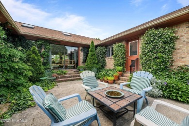 This Mediterranean-style brick home offers panoramic views of on Harbour Point Golf Club in North Carolina - for sale on GolfHomes.com, golf home, golf lot