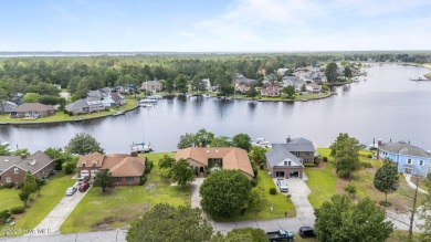 This Mediterranean-style brick home offers panoramic views of on Harbour Point Golf Club in North Carolina - for sale on GolfHomes.com, golf home, golf lot