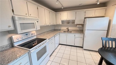 This second floor end-unit is a must see! It features a on The Glades Golf and Country Club in Florida - for sale on GolfHomes.com, golf home, golf lot