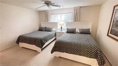 This second floor end-unit is a must see! It features a on The Glades Golf and Country Club in Florida - for sale on GolfHomes.com, golf home, golf lot