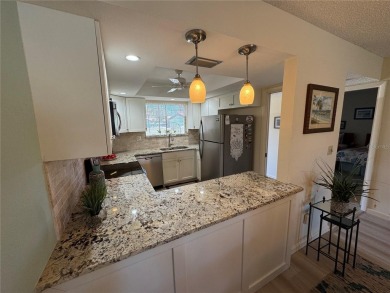 Starting from the colorfully landscaped front entrance to the on IMG Academies Golf and Country Club in Florida - for sale on GolfHomes.com, golf home, golf lot
