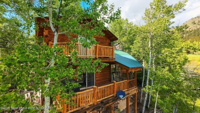 Experience the charm of rustic elegance at 590 Walnut Drive on Star Valley RV Golf Course in Wyoming - for sale on GolfHomes.com, golf home, golf lot
