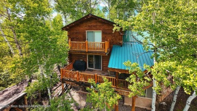 Experience the charm of rustic elegance at 590 Walnut Drive on Star Valley RV Golf Course in Wyoming - for sale on GolfHomes.com, golf home, golf lot