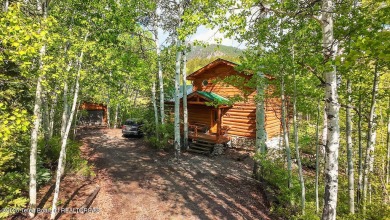 Experience the charm of rustic elegance at 590 Walnut Drive on Star Valley RV Golf Course in Wyoming - for sale on GolfHomes.com, golf home, golf lot