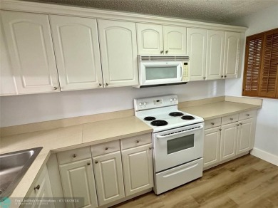 Beautiful bright and airy unit overlooking the lake and on Pine Island Ridge Country Club in Florida - for sale on GolfHomes.com, golf home, golf lot