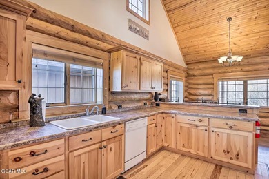 Tucked in the heart of Granby, this enchanting log cabin on Grand Elk Ranch and Club in Colorado - for sale on GolfHomes.com, golf home, golf lot