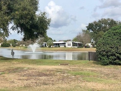 PRICE JUST IMPROVED on This Blue Coral model AND it has a WATER on Water Oak Country Club Estates in Florida - for sale on GolfHomes.com, golf home, golf lot