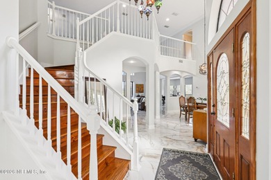 All brick two-story Eagle Harbor home with pond and fairway on Eagle Harbor Golf Club in Florida - for sale on GolfHomes.com, golf home, golf lot